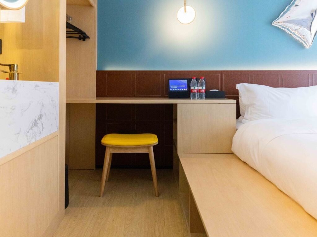 Modern hotel furniture with coordinated bed casegoods desk and lounge seating