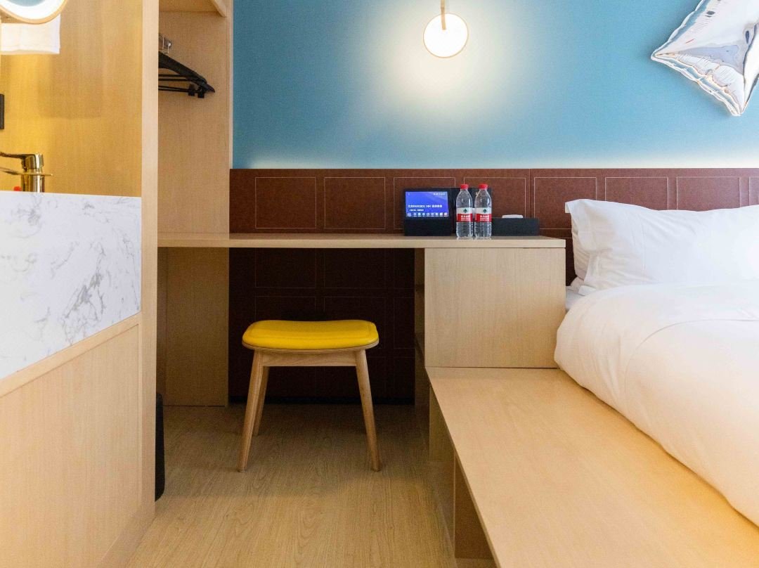 Modern hotel furniture with coordinated bed casegoods desk and lounge seating