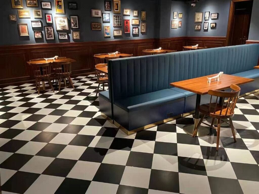 Commercial restaurant dining tables with wood finish tops and metal bases arranged in a modern dining area