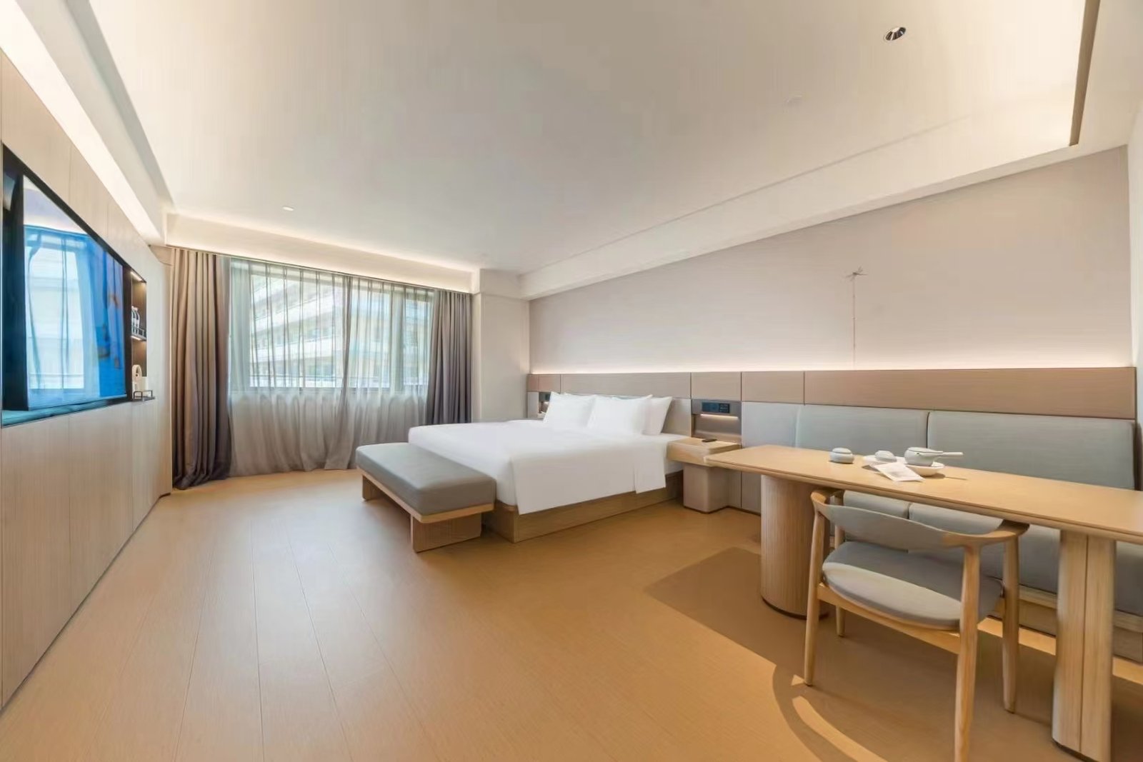 Hotel room furniture package with custom casegoods bed seating and coordinated finishes